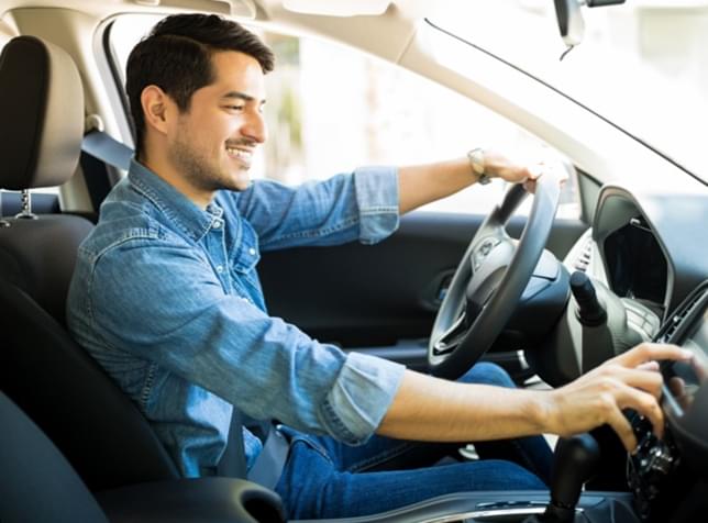 Man in driver's seat of car - link to The General Mexico Travel Insurance page